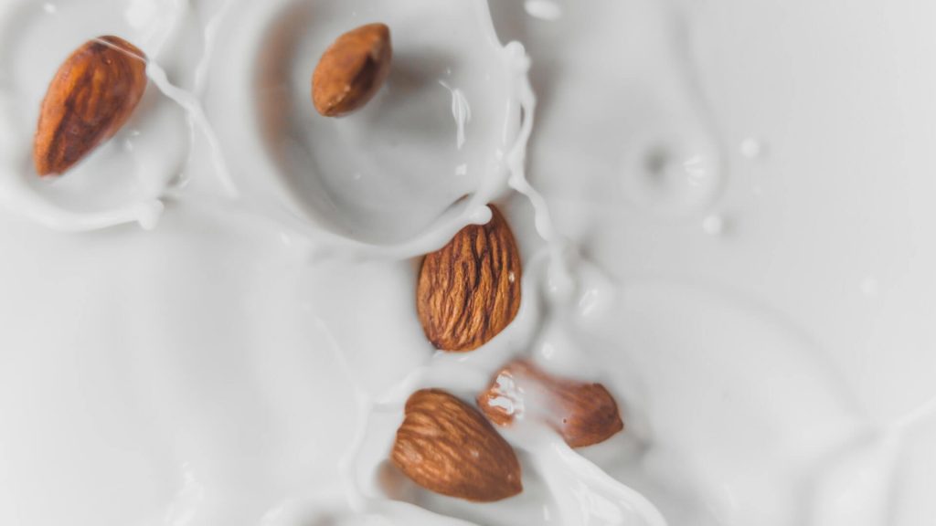 A glass filled with almond milk, a popular non-dairy milk substitute.