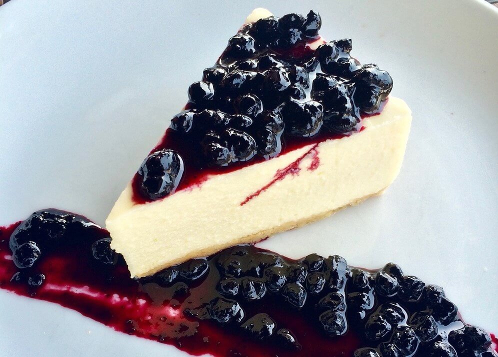 A luscious and creamy vegan berry cheesecake made with a nut-based crust and a rich filling made from cashews, coconut milk, and mixed berries.